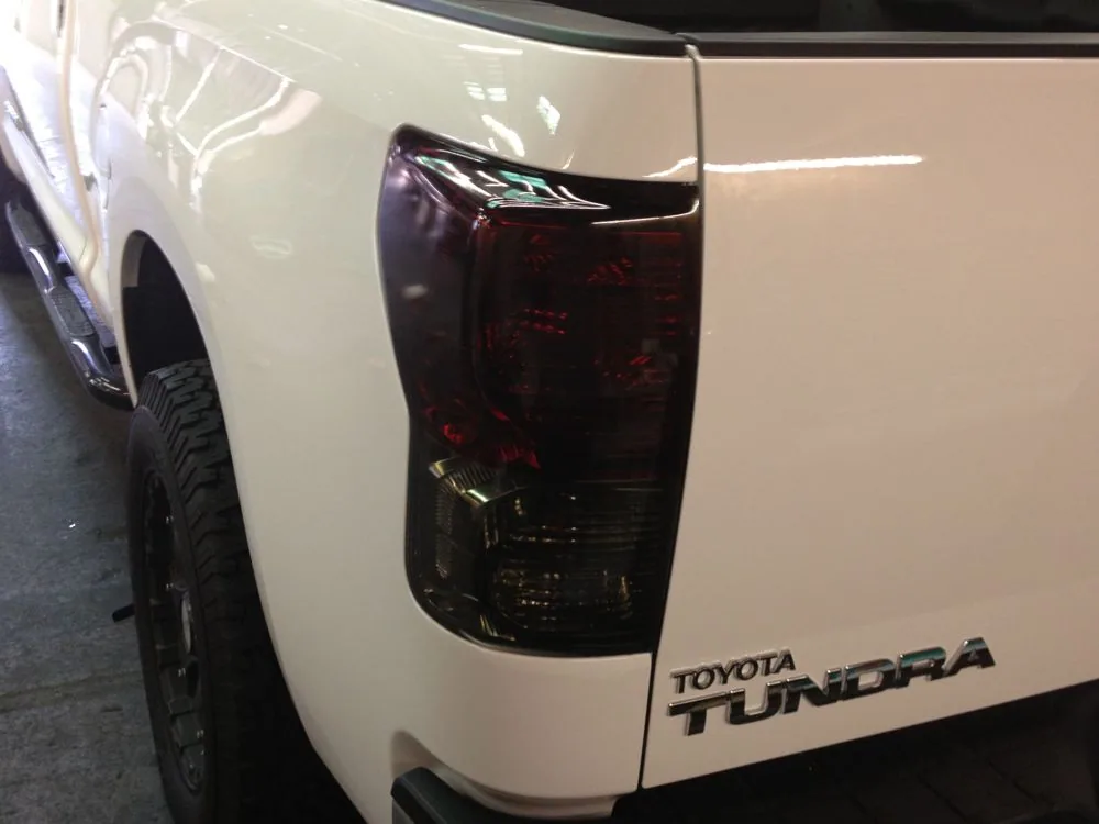 White Toyota Tundra pickup truck with darkly tinted taillight assembly