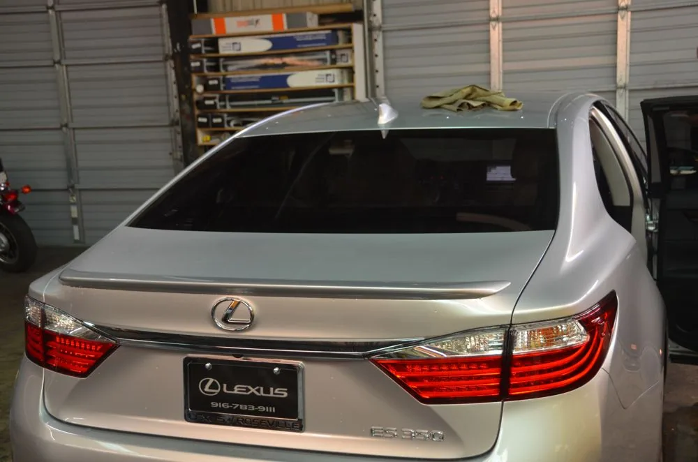 Silver Lexus sedan parked in garage with tinted windows and red LED taillights